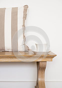 Wooden bench with coffee and pillows in living room