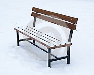 Wooden bench covered with snow - winter time Christmas