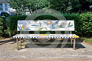 Wooden bench with elf and flowers in street art design on the Baltic Sea. Street bank in Binz on the island of RÃ¼gen