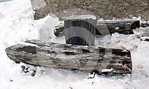 Wooden bench log and snow in Dolomity mountains, winter image
