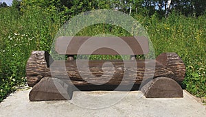 wooden bench of logs in the background of the forest