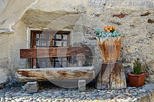 Wooden bench made of tree trunks - Engadin valley Switzerland