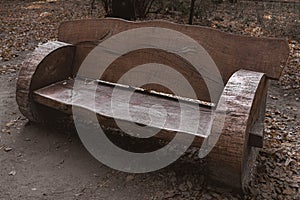 A wooden bench of original design in an autumn park