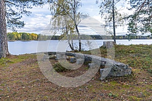 Wooden bench outdoors by a lake