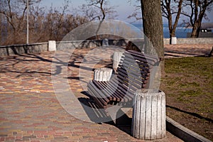 Wooden bench in the park in early spring