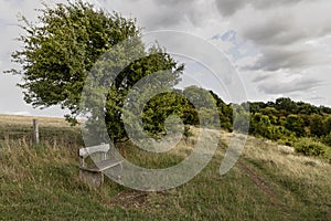 Wooden bench seat on hilltop