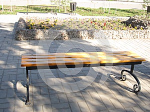 Wooden bench on the sidewalk