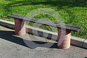 Wooden bench at sidewalk