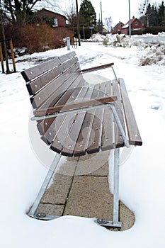 Wooden bench in snow