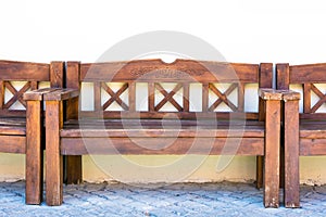 Wooden bench stands behind the house near the wall