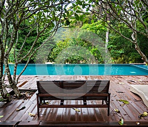 Wooden bench by the swimming pool.