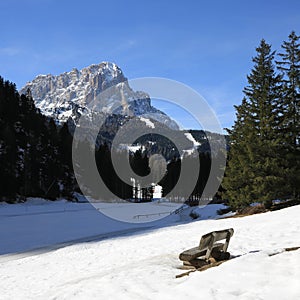 Wooden bench with view of the Langkofel, mountain in South Tirol