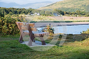 Wooden bench viewing point overlooking Tralee Bay near Oban in S