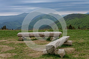 Wooden benches in mountain pass Medziholie in national park Mala Fatra, natural reserve Velky Rozsutec, Slovakia, spring cloudy