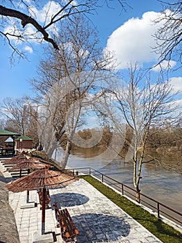 wooden benches and parasols on the bank of the river Morava, Jagodina, Serbia