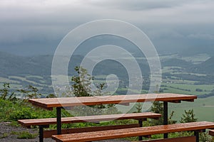 Wooden benches and table, view from Javornik to mountain village in Beskid Mountains