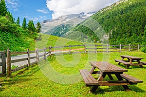 Wooden benches to picnic in Alpine valley, Austria