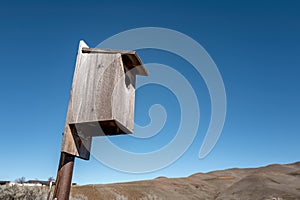 Wooden birdhouse out in nature to help conserve bird wildlife