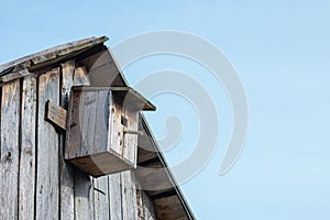 Wooden birdhouse on a wooden barn wall 3