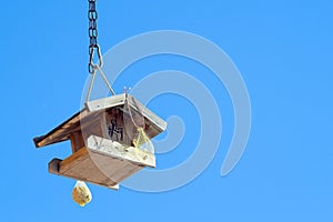 Wooden birds house (starling-house) on the blue sky