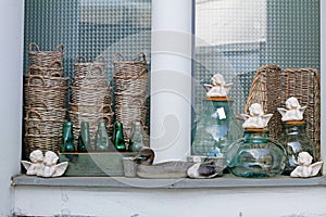 Wooden birds, wicker baskets, ceramic angels, flowerpots, glass bottles and jars in flower shops