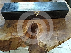 the wooden black box on the table photo