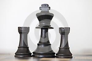 Wooden black king and rooks chess pieces