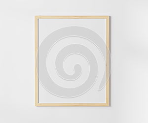 Wooden blank frame on white wall mockup, 4:5 ratio - 40x50 cm, 16 x 20 inches, poster frame mockup, 3d rendering.