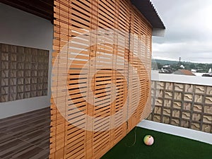 Wooden Blinds on Balcony with Ball.