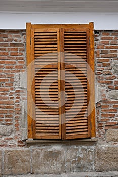 Wooden blinds on windows on the street