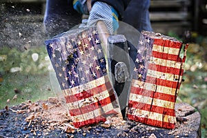 Wooden block with American flag is split in two halves with an axe, metaphor for the divided country after the election