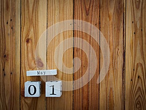 Wooden block calendar 1 May and Joinery tools on a wooden table