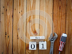 Wooden block calendar 1 May and Joinery tools on a wooden table