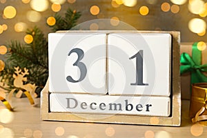 Wooden block calendar and Christmas decor on table. Holiday countdown