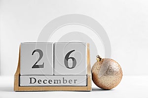 Wooden block calendar and decor on light background. Christmas countdown