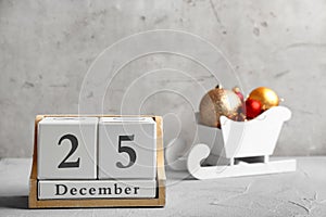 Wooden block calendar and decor on table. Christmas countdown