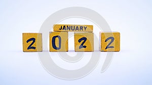 Wooden block calendar for January 2022. Yellow on a white background