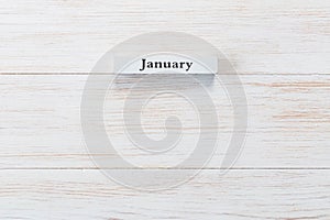 Wooden block of calendar with month January on wood background