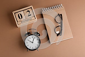 Wooden block calendar, notebook and alarm clock