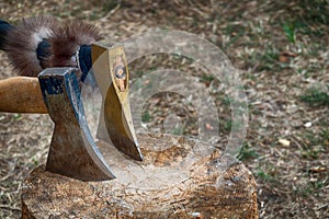 Wooden block for chopping wood with two hand axes