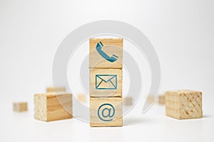 Wooden block cube symbol telephone, email, address. Website page contact us or e-mail marketing concept