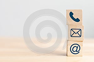 Wooden block cube symbol telephone, email, address. Website page contact us or e-mail marketing concept