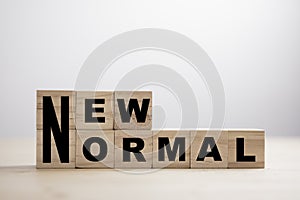 Wooden block cubes for new normal wording. The world is changing to balance it into new normal include business , economy ,