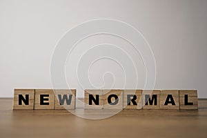 Wooden block cubes for  new normal wording. The world is changing to balance it into new normal include business , economy ,