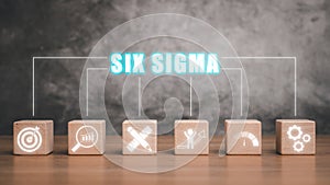 Wooden block on desk with six sigma icon on virtual screen