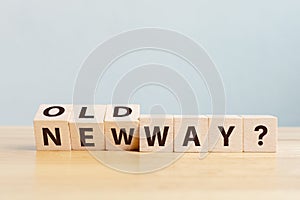 Wooden block flip word on table with word old way and new way