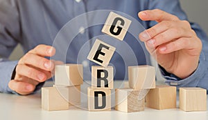 Wooden block form the word Gerd with stethoscope on the doctor's desktop, medical concept