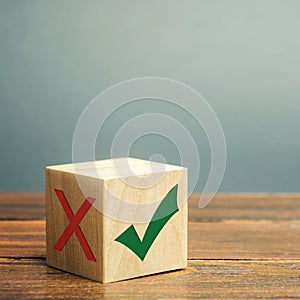 Wooden block with a green check mark. The concept of choice and making the right decision. Business management. Plan, planning.