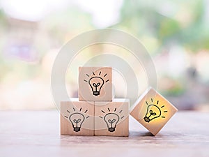 Wooden block with light bulb and wooden block with question mark for leadership, creative, idea, innovation concept