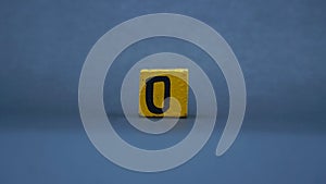 Wooden block with number 0. Yellow color on dark background